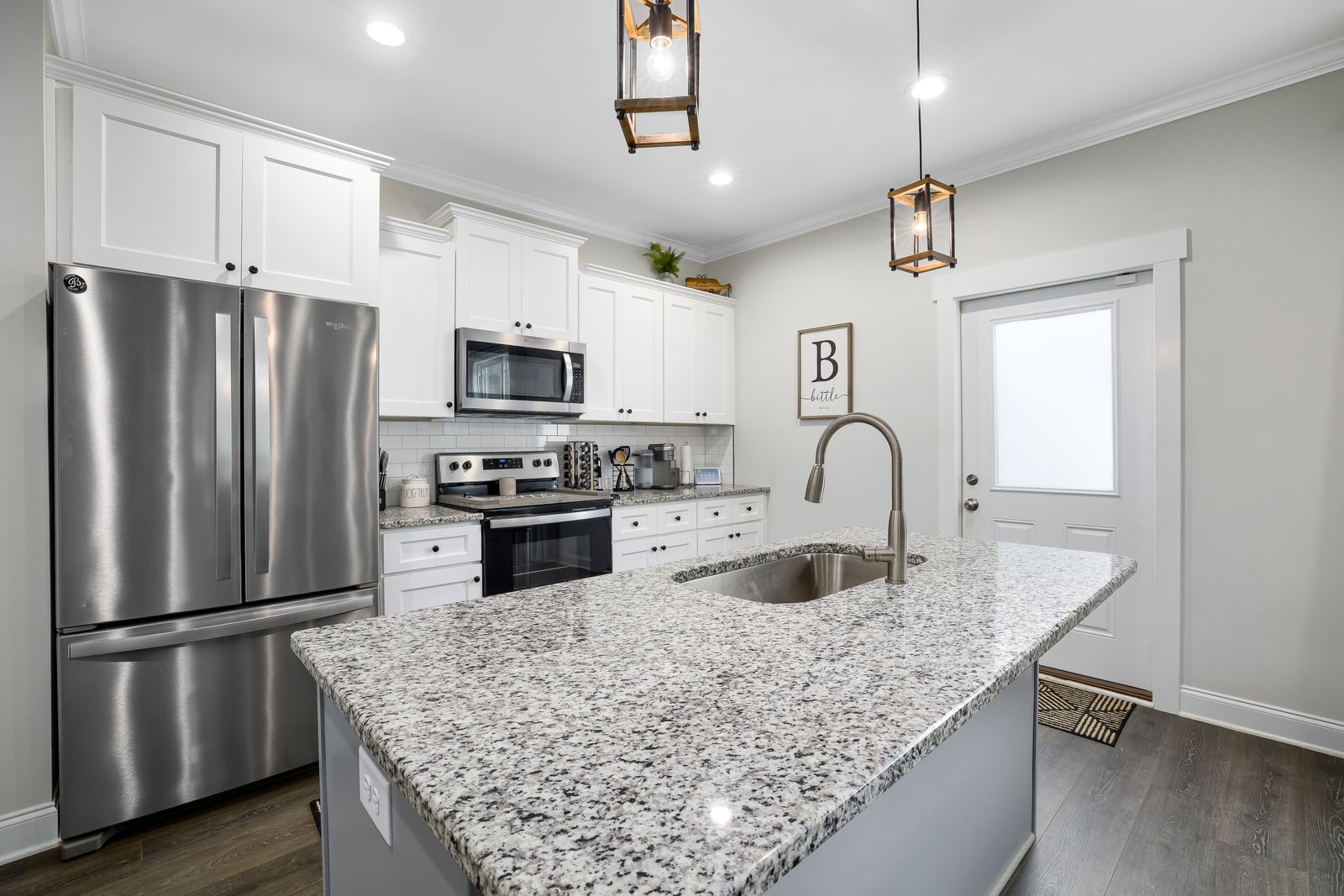 A freshly renovated modern kitchen with new cabinets and an island